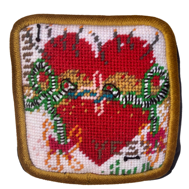 needlepoint kissing snakes on a heart