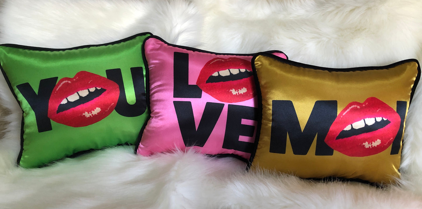 hot pink pillow with blackletters - L, red lips for an O, V & E stacked underneath