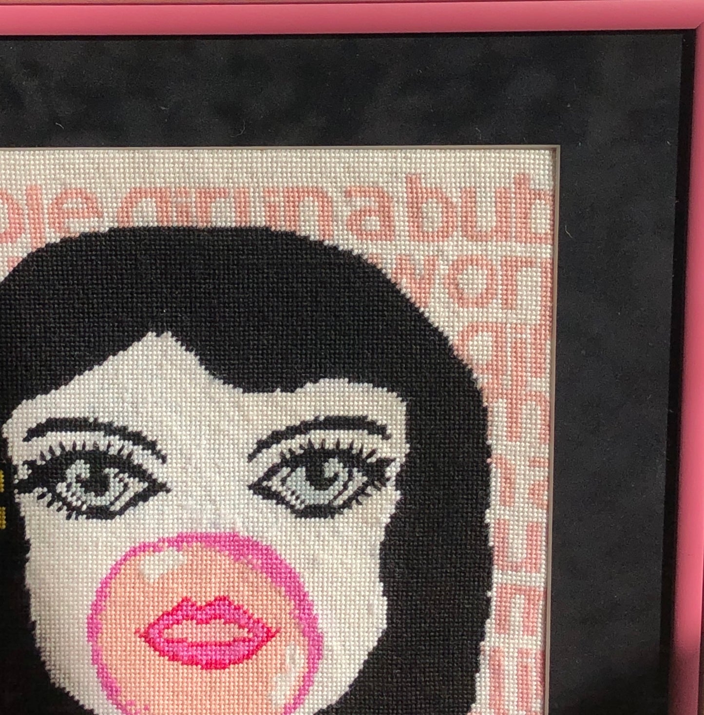 needlepoint big-eyed girl blowing pink bubble & hair flipped up, BUBBLE GIRL IN A BUBBLE GUM WORLD text behind image