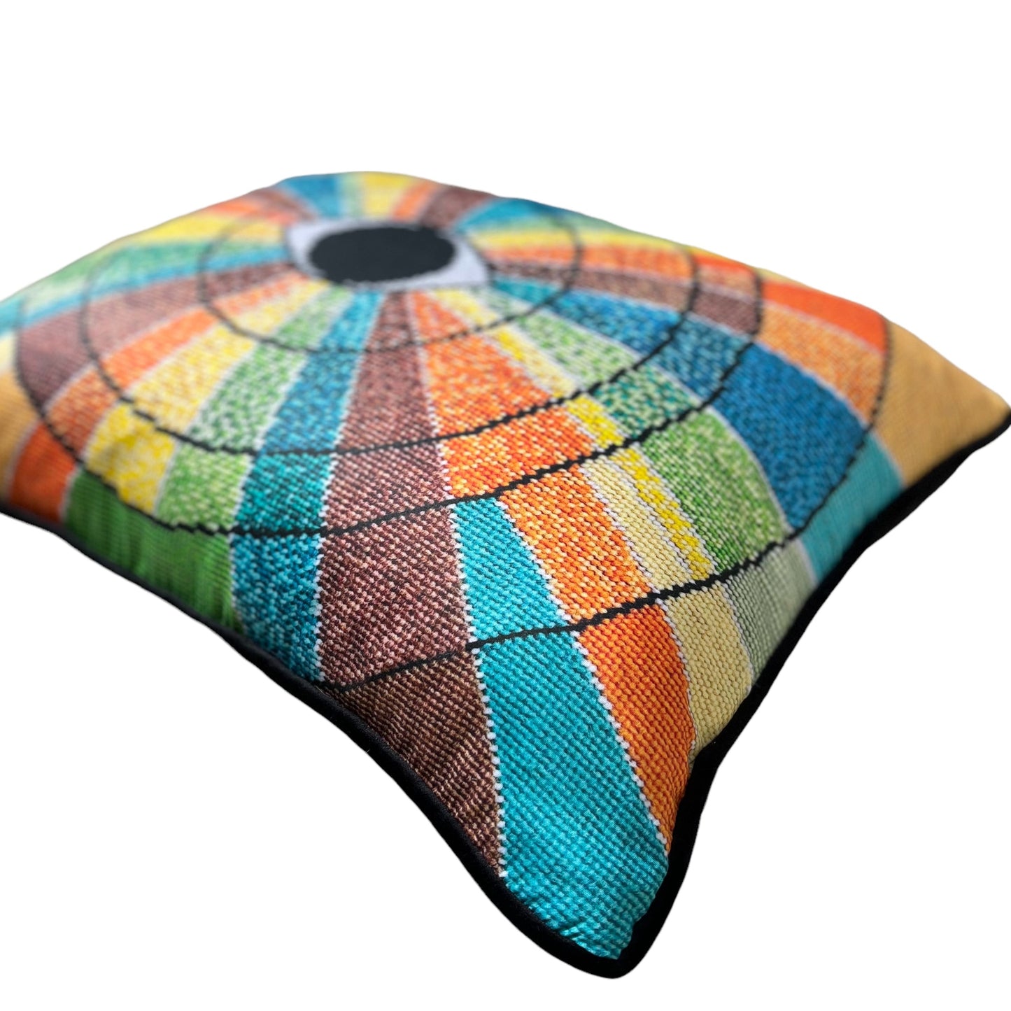 pillow has eye centered design with variegated rays of color - turquoise, green, brown, orange, yellow