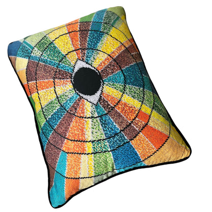 pillow has eye centered design with variegated rays of color - turquoise, green, brown, orange, yellow
