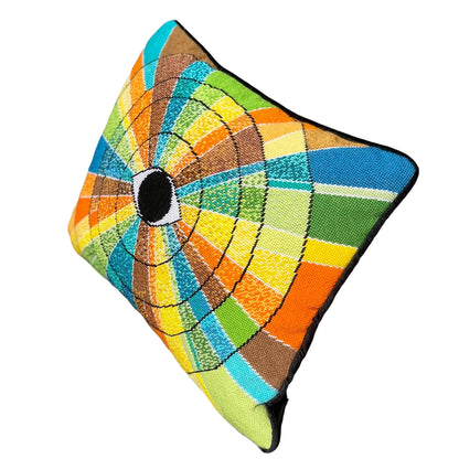 pillow has eye centered design with variegated rays of color - turquoise, green, brown, orange, yellow