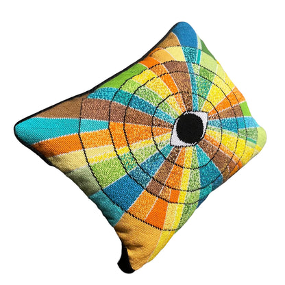 pillow has eye centered design with variegated rays of color - turquoise, green, brown, orange, yellow