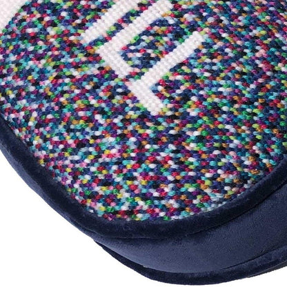 sculpted pill shape pillow is one-half white with blue letters and one half dotted, colorful pattern with PILL written in white  