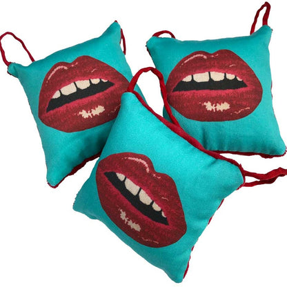 puffed pillow square ornament full red lips with open mouth and gapped teeth on turquoise background