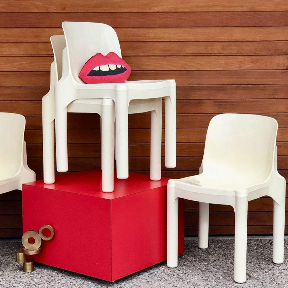 sculpted red lips pillow on modern white chair