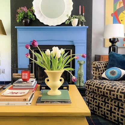 blue eye sculpted pillow with yellowThe Rath Project . . table, blue fireplace, tulips arrangement