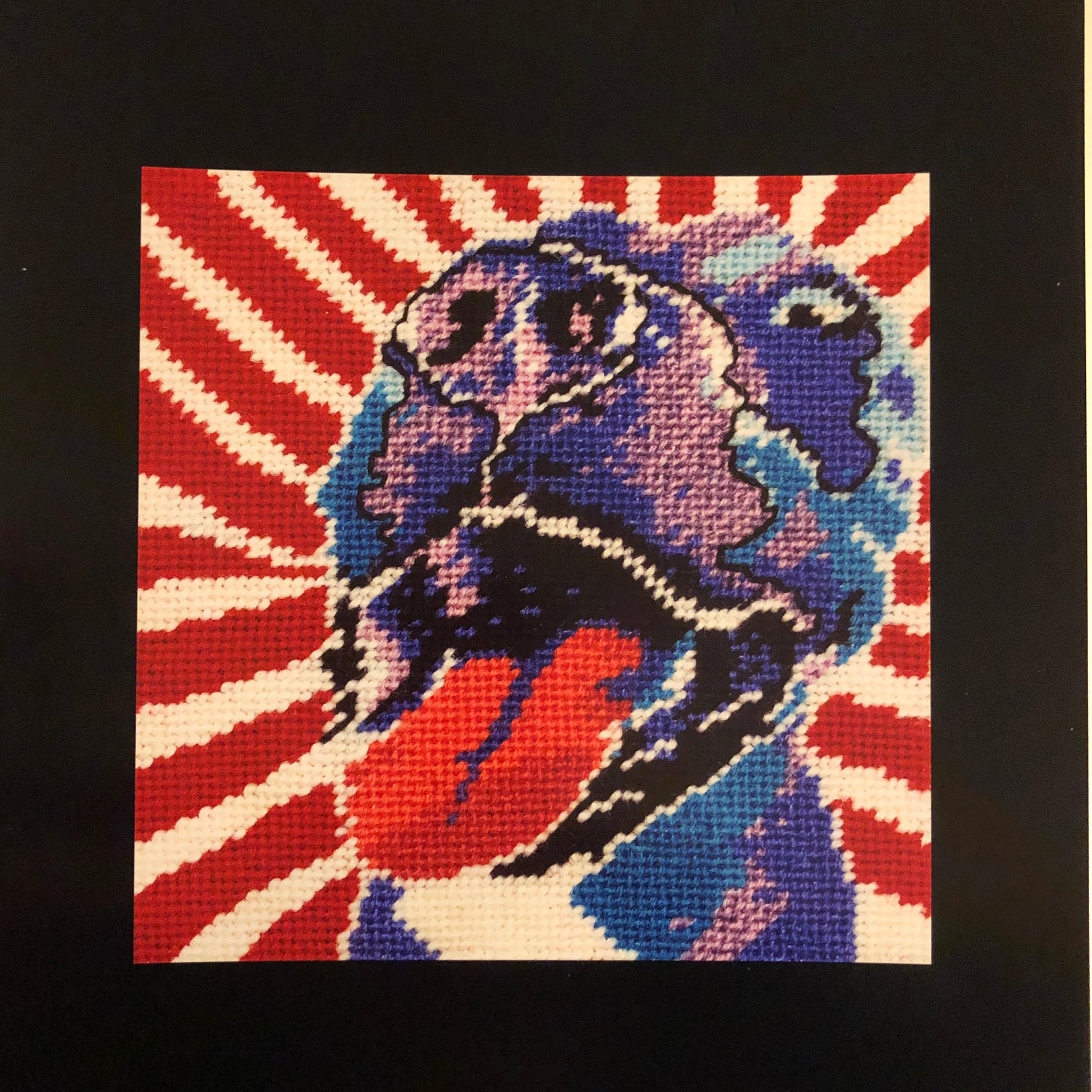 Americana style purple dog print with big smile & tongue falling out, red & white diagonal background