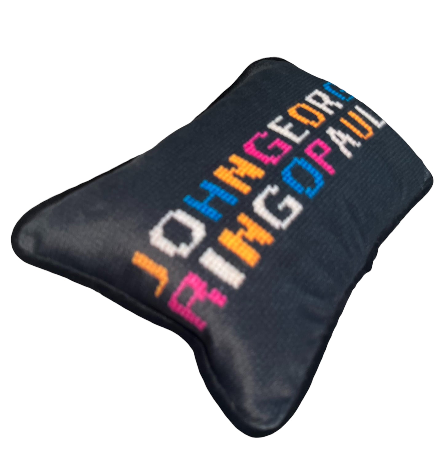JOHNGEORGE on top line;  RINGOPAUL written in colorful yellow, white, blue and pink letters on solid black background.  The Beatles pillow.