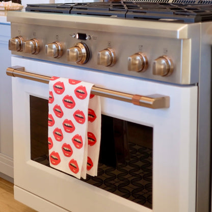 white cotton linen tea towel with red lips all over