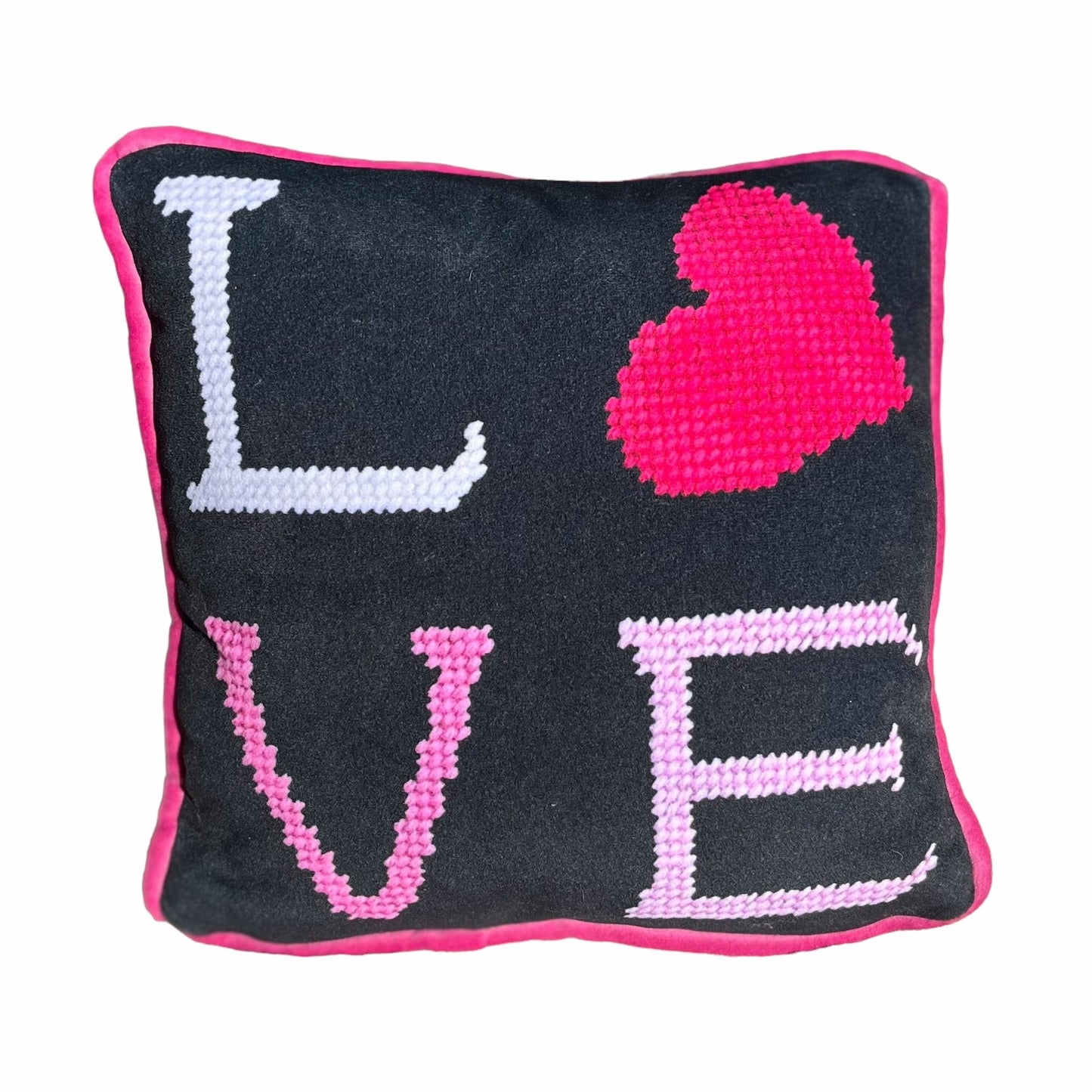 black velvet pillow with white L, hot pink heart on top; bubble gum V and baby pink E stacked underneath