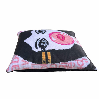 velvet pillow of doe-eyed girl with Jackie O hair and yellow hair clamp, blowing a bubble