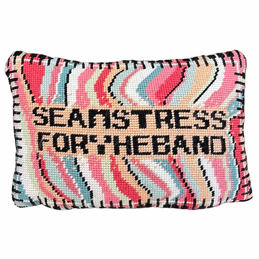 SEAMSTRESS FOR THE BAND stitched in black inside tan box, surrounded by wavy bands of turquoise, pink, red, white, lime and a keyboard border