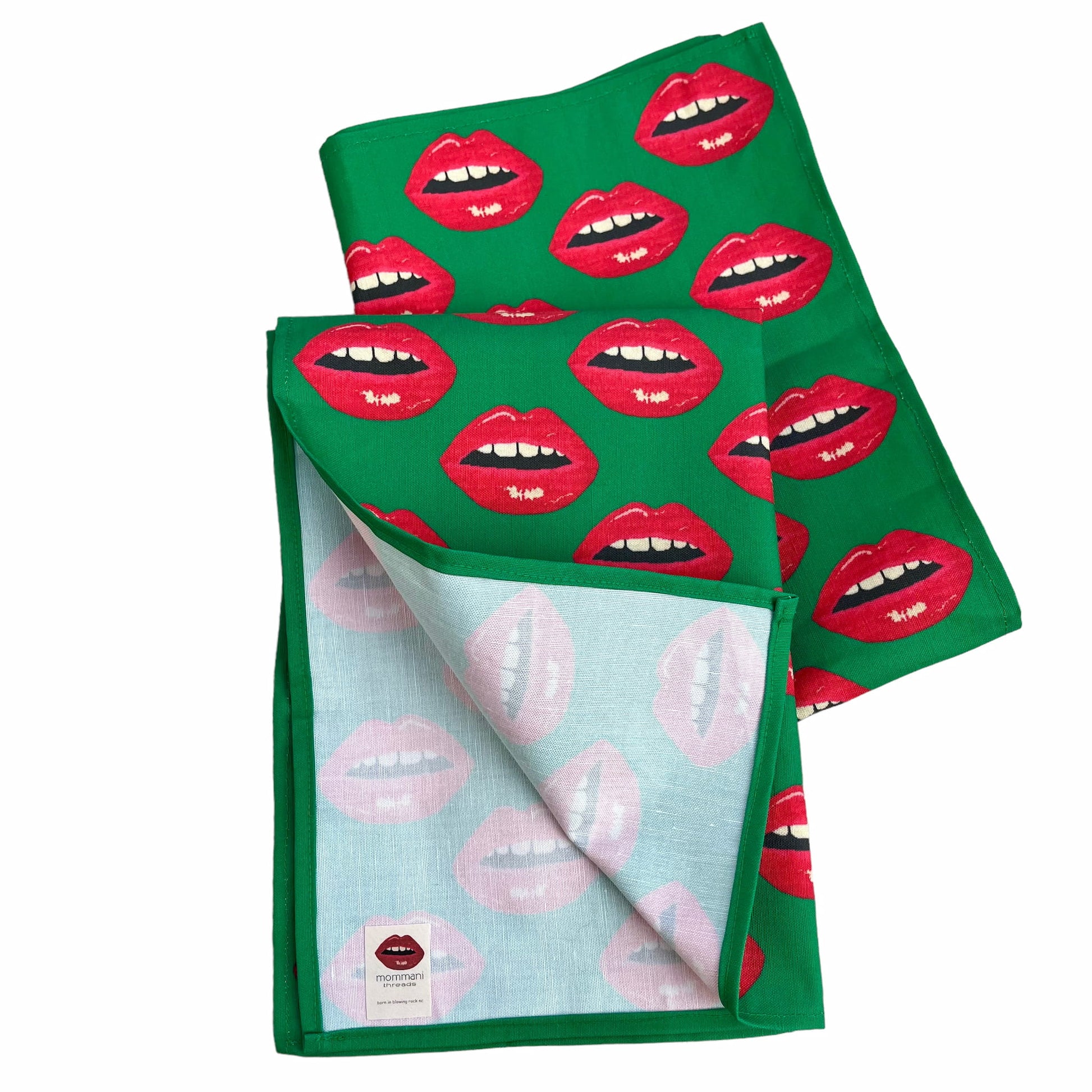 Christmas green tea towel covered in red lips