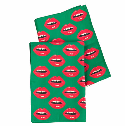 Christmas green tea towel covered in red lips