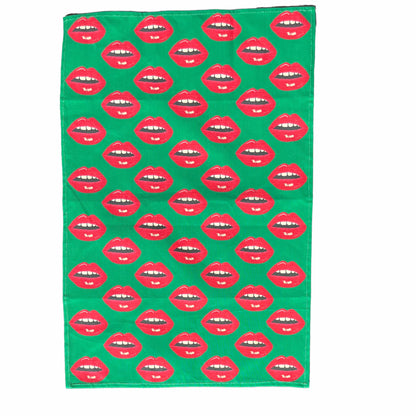 Christmas green tea towel covered in red lips