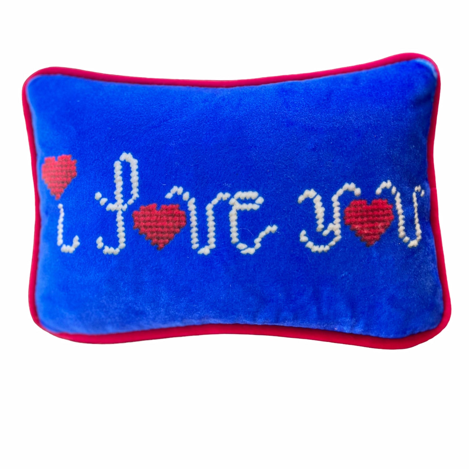 blue velvet pillow with I LOVE YOU written cursive script, the dot on the i and o in love and you is a red heart