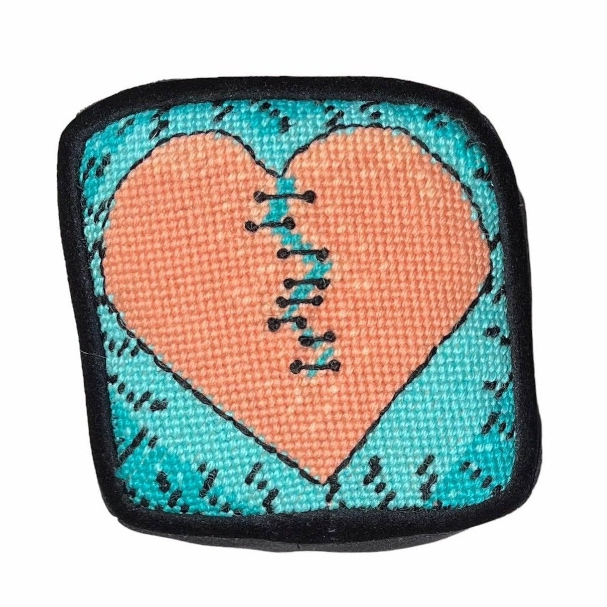 Variegated orange broken-heart pillow with turquoise background