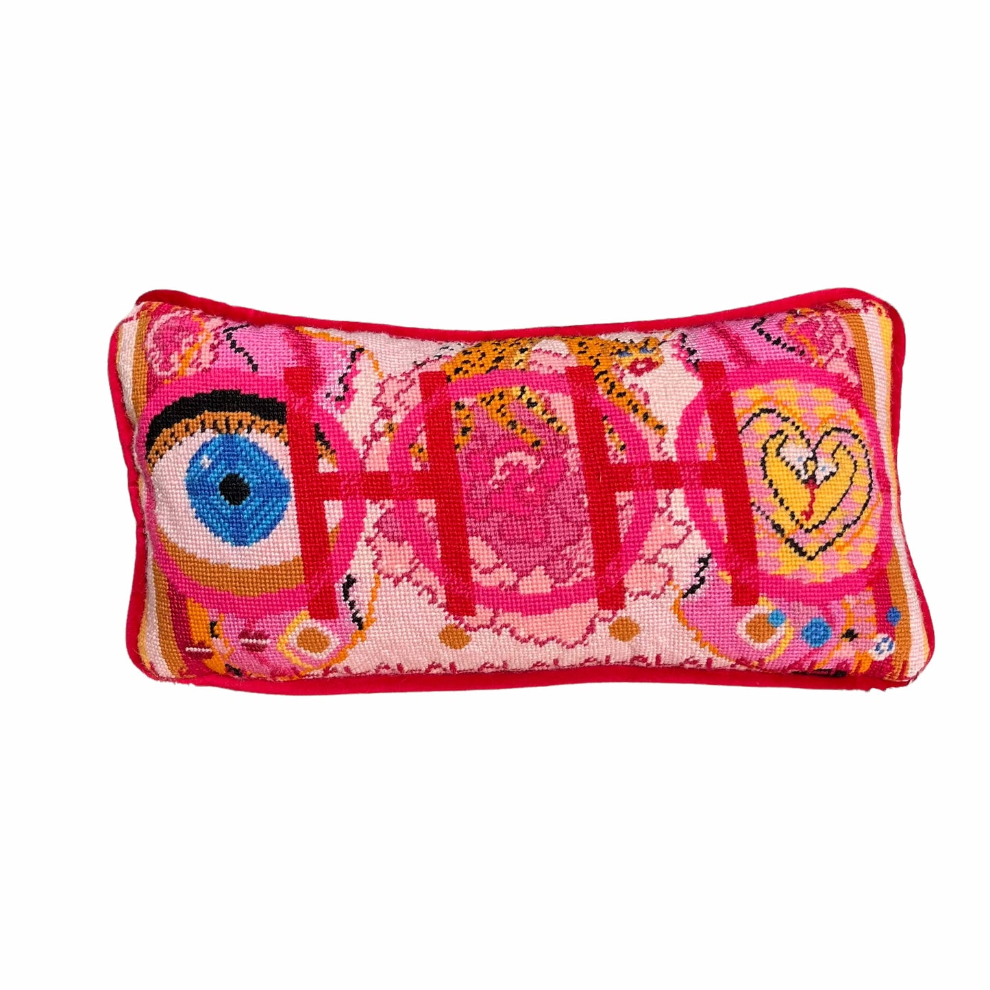 needlepoint pillow with pink and red colorful pattern, blue eye, cheetah, heart snakes, roses and lettering OOH in center with a LA LA LA border