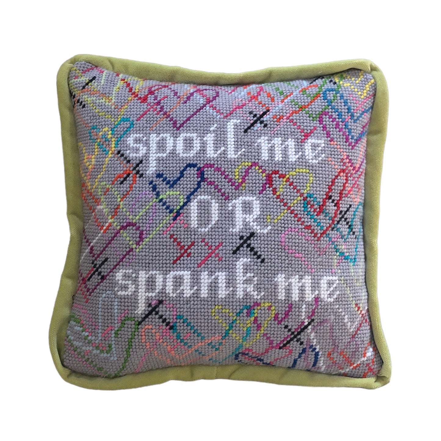 needlepoint SPOIL ME OR SPANK ME in white, surrounded by brightly colored hearts and a soft gray background
