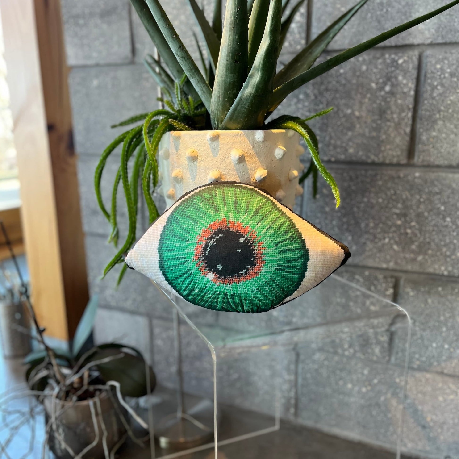 green eye sculpted pillow has gold at center, gradually turning to a dark green- very detailed
