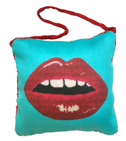 puffed pillow square ornament full red lips with open mouth and gapped teeth on turquoise background