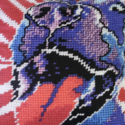 Americana style purple dog big pillow with big smile & tongue falling out, red & white diagonal background