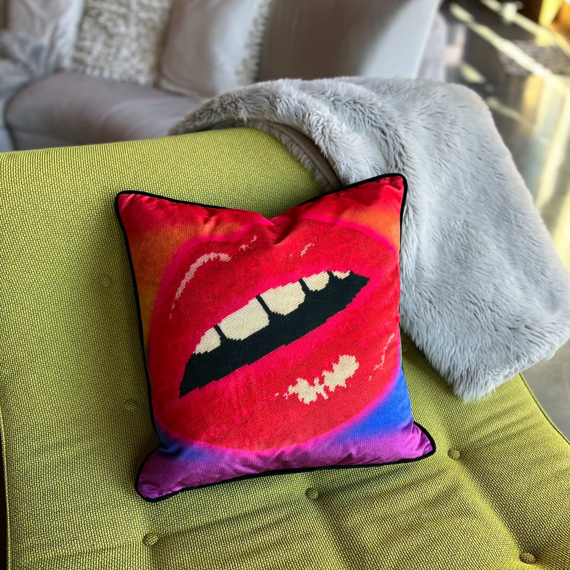 rainbow velvet pillow with large lips highlighted in neon pink