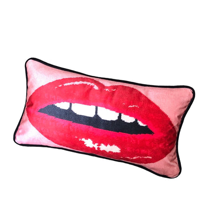 pink velvet lumbar pillow with red lips with open mouth and gapped teeth