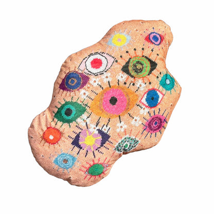 velvet amoeba-shaped pillow covered in fanciful, brightly-colored-eyes