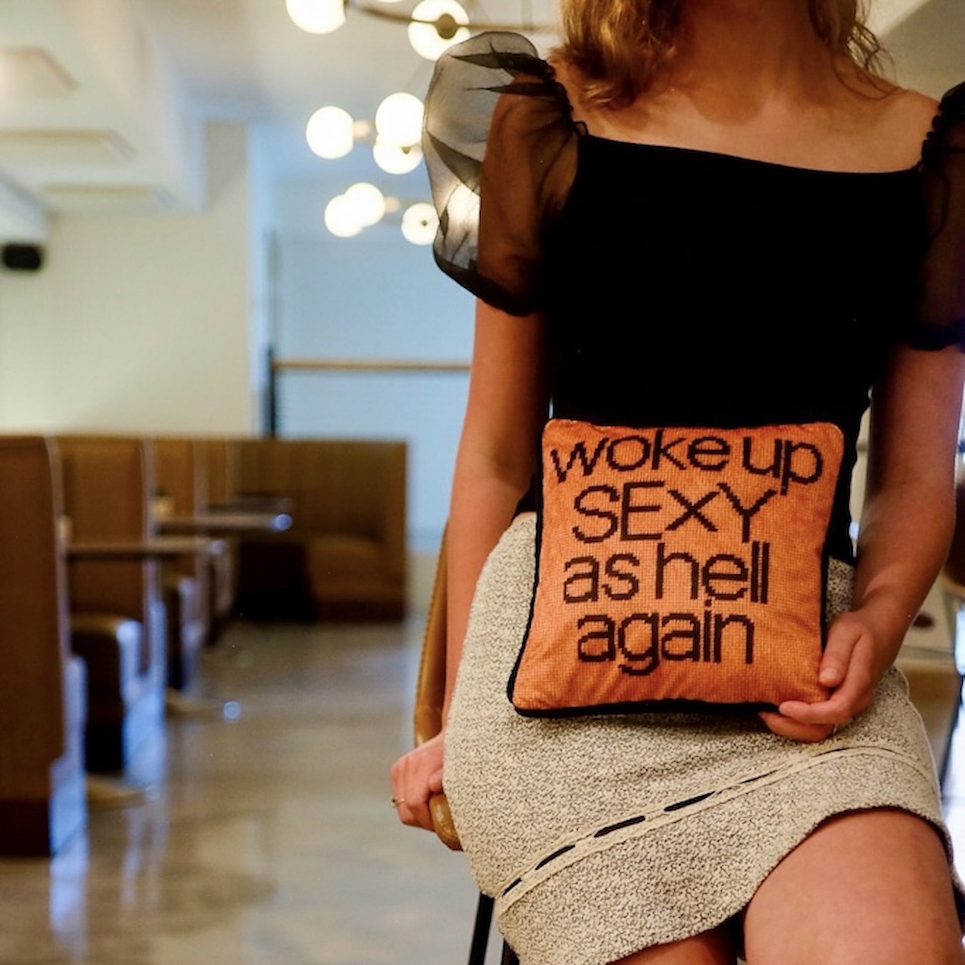 velvet copper pillow with WOKE UP SEXY AS HELL AGAIN black text