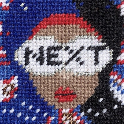 red, white & blue pillow with lady centered, flipped black hair, pearl necklace and sunglasses that say NEXT