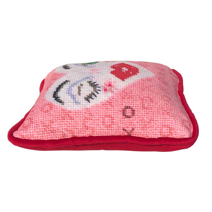 white heart pillow with winking eye and green eye, full lips, pink background with X and O