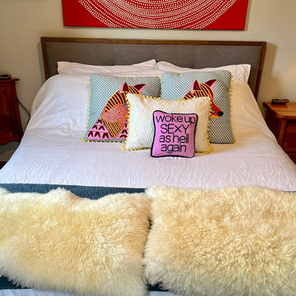woke up sexy as hell in black, centered on pillow with pink background on bed