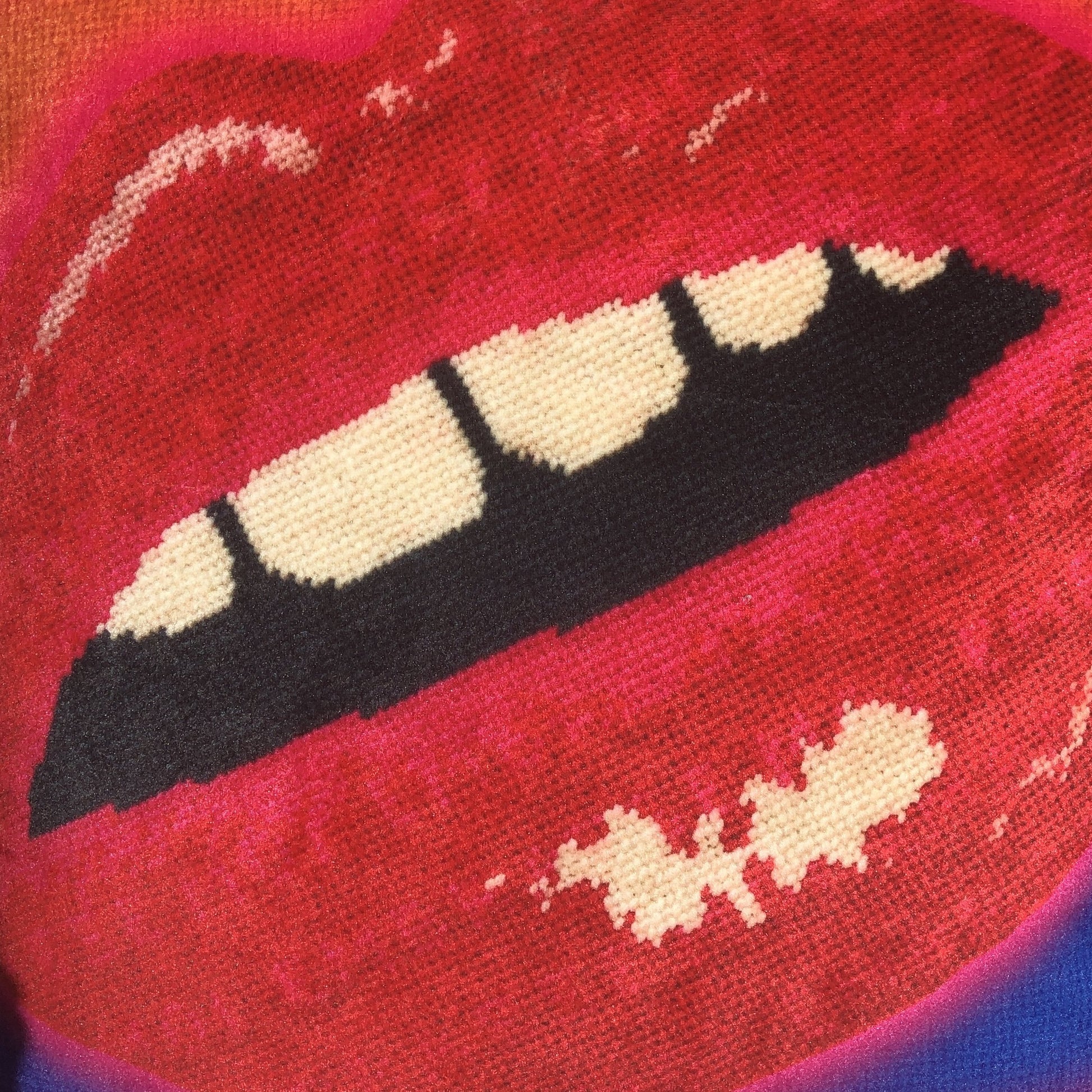 rainbow velvet pillow with large lips highlighted in neon pink