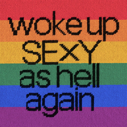 black text with woke up sexy as hell again centered on pillow on rainbow flag background