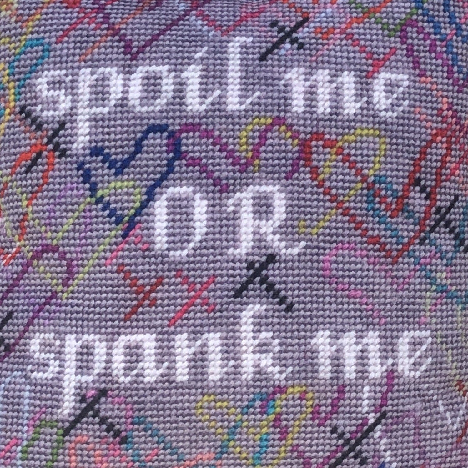 SPOIL ME OR SPANK ME in white, surrounded by brightly colored hearts and a soft gray background