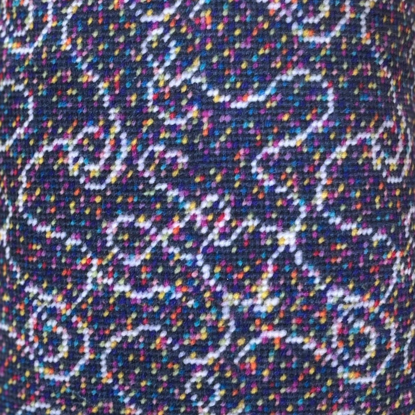 velvet fabric with white swirls on gray background with tiny multi-colored dots