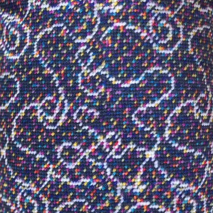 velvet fabric with white swirls on gray background with tiny multi-colored dots